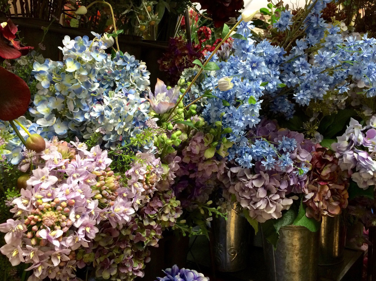 Collection of silk flowers in vases