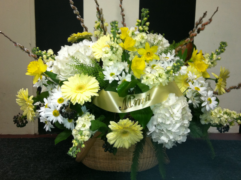 Yellow and white funeral flower arrangement