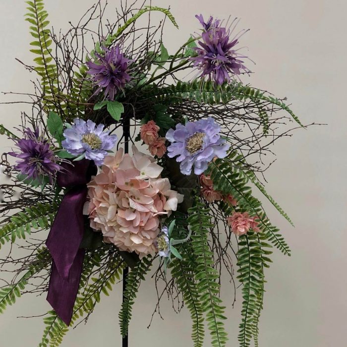 Silk flower wreath with purple and pink accents 