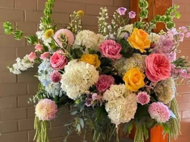 Funeral fresh flower arrangement with yellow roses
