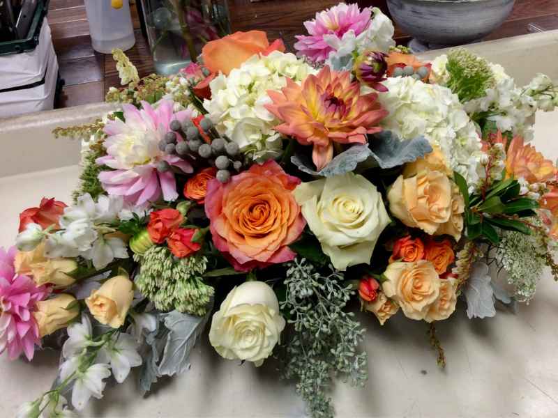 Funeral flower casket spray with roses